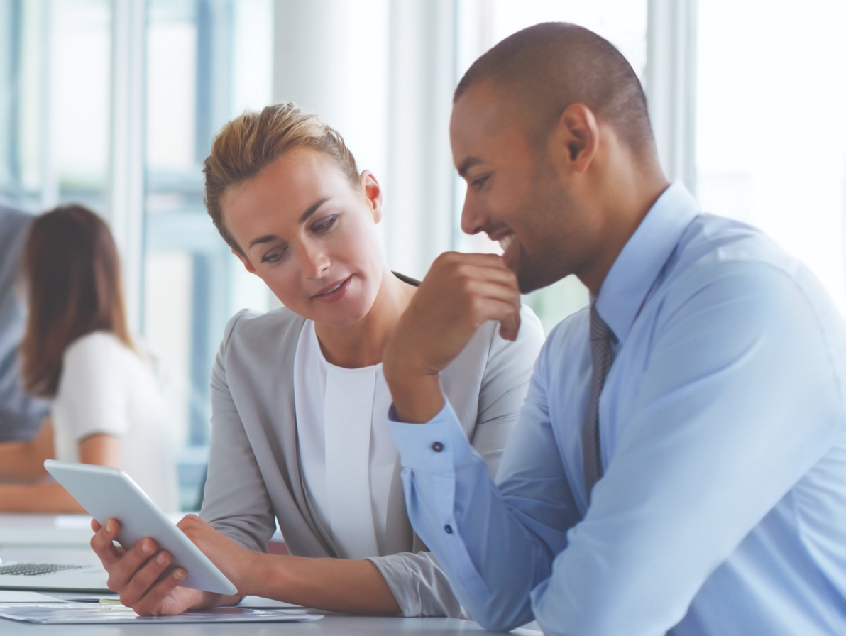 Man & woman looking at a tablet together